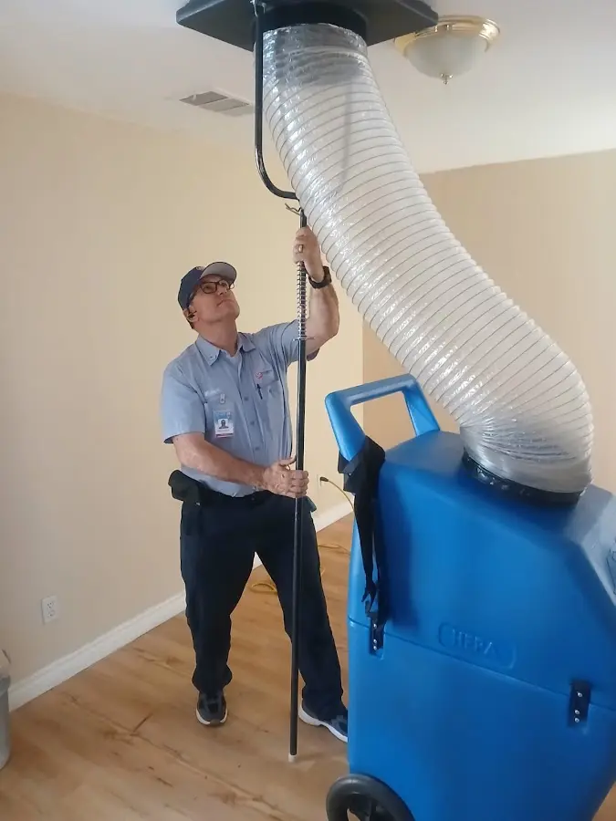 Furnace Tune-Up technician using HEPA equipment in Friendswood